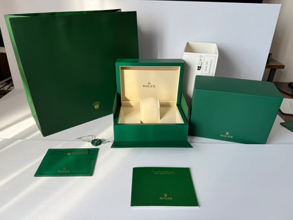 Emerald luxury watch display case with open lid and soft interior cushion