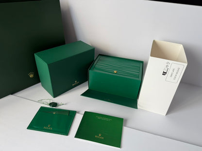 Luxury emerald watch case close-up showing interior cushion and details